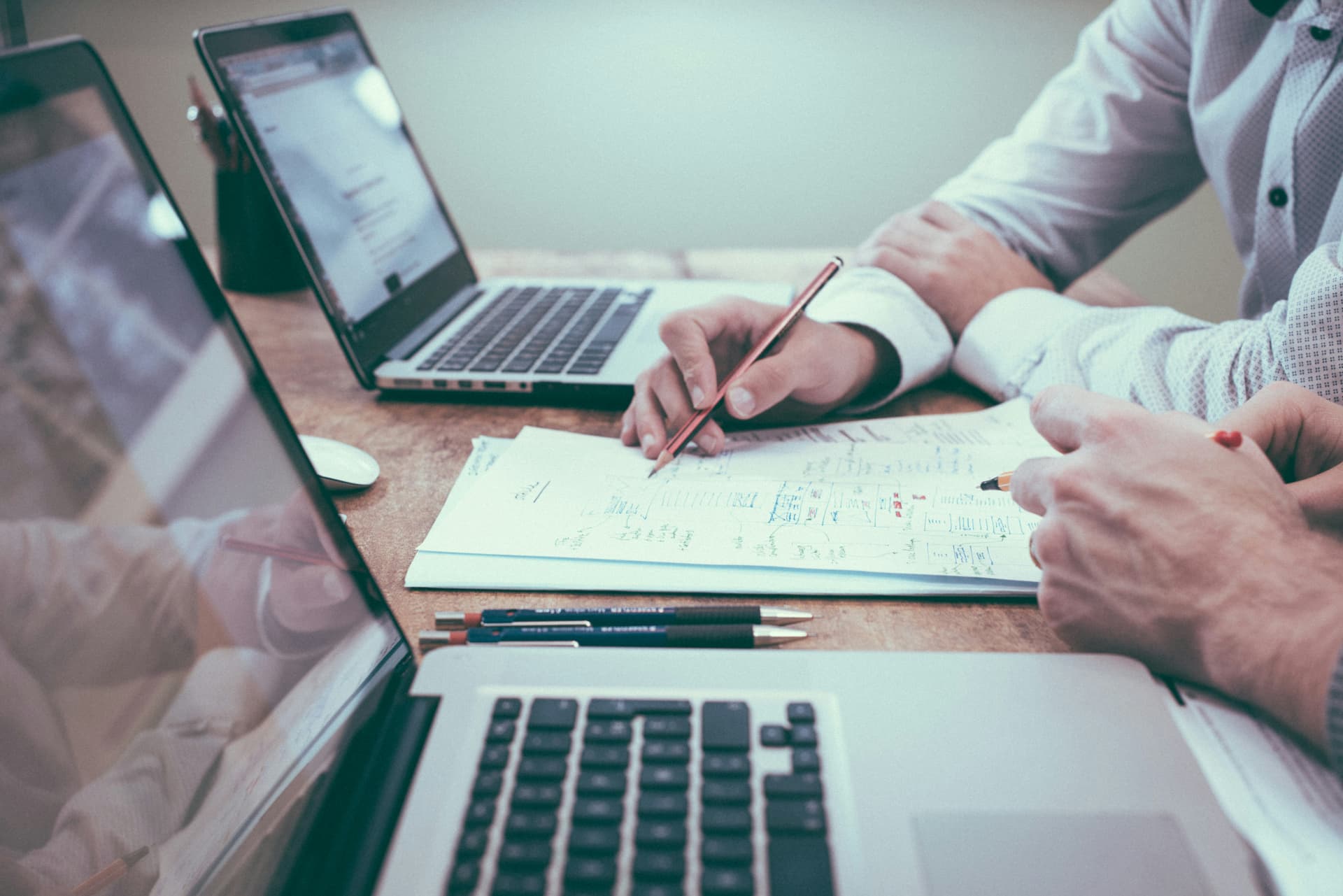 A person writing notes as part of business planning and follow-up.