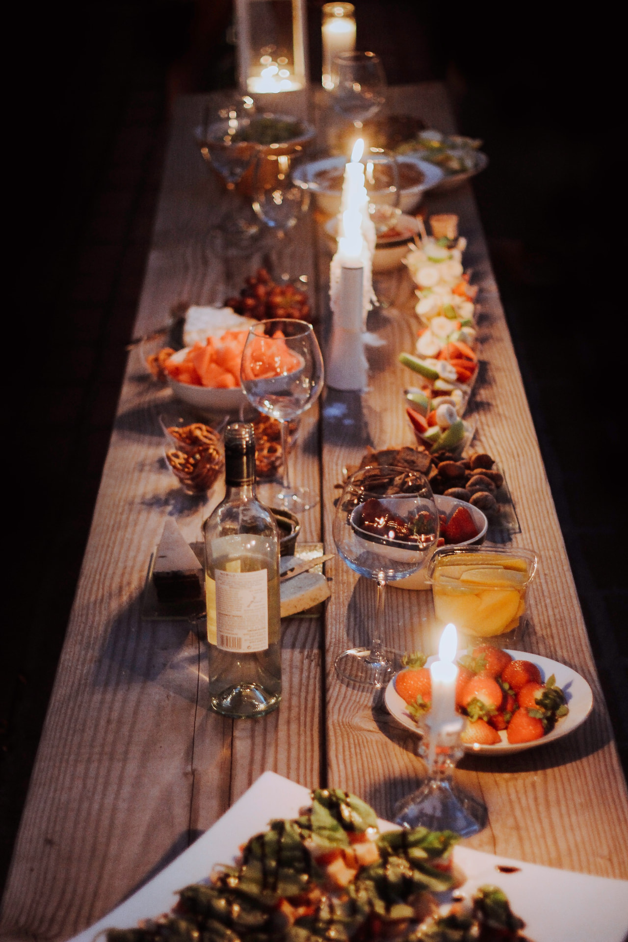 A warmly lit dinner table set for a client appreciation gathering.